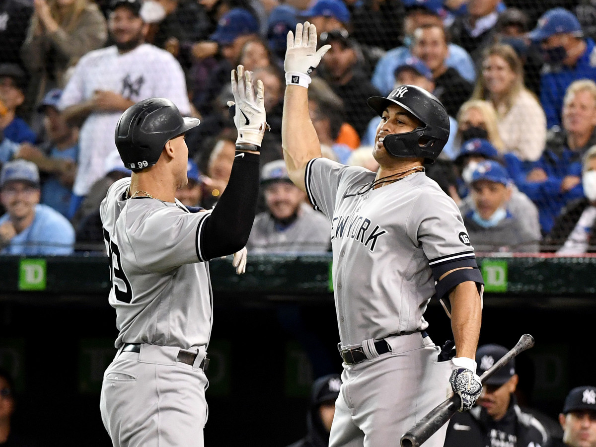 Sep 30, 2021; Toronto, Ontario, CAN;   New York Yankees right fielder Aaron Judge (99) is greeted by left fielder Giancarlo Stanton (27) after hitting a solo home run against Toronto Blue Jays in the first inning at Rogers Centre.